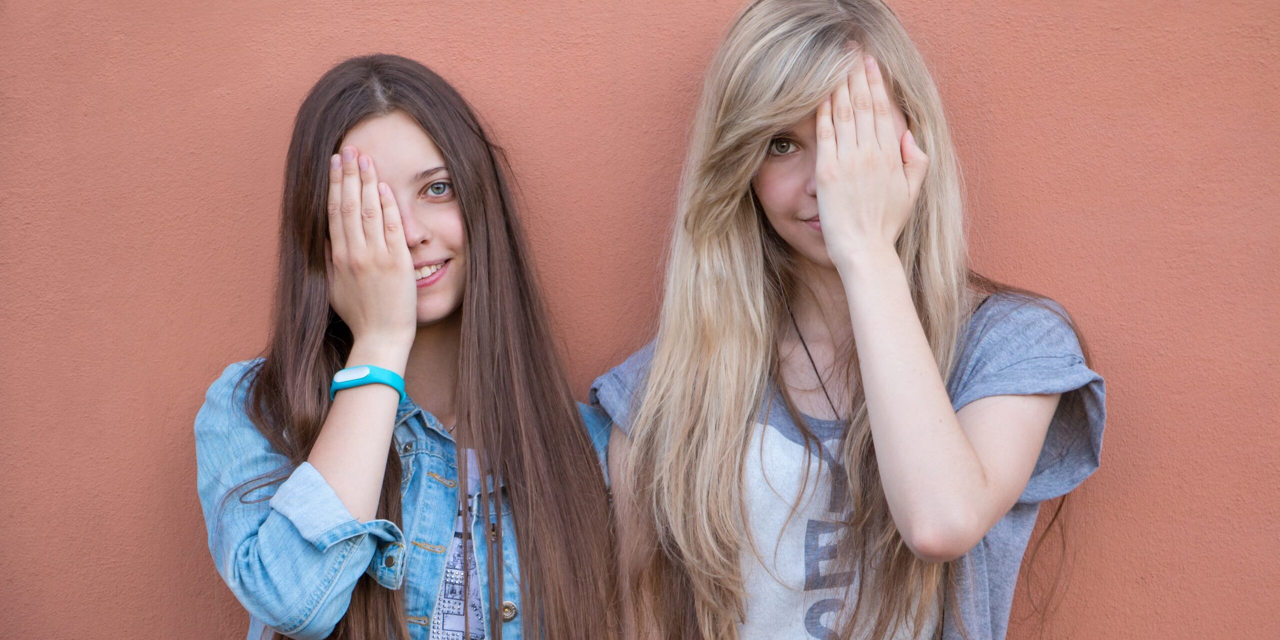 beautiful-happy-girls-close-their-eyes-with-their-hands-college-life-young-friendship-happy-people_t20_BEwREr