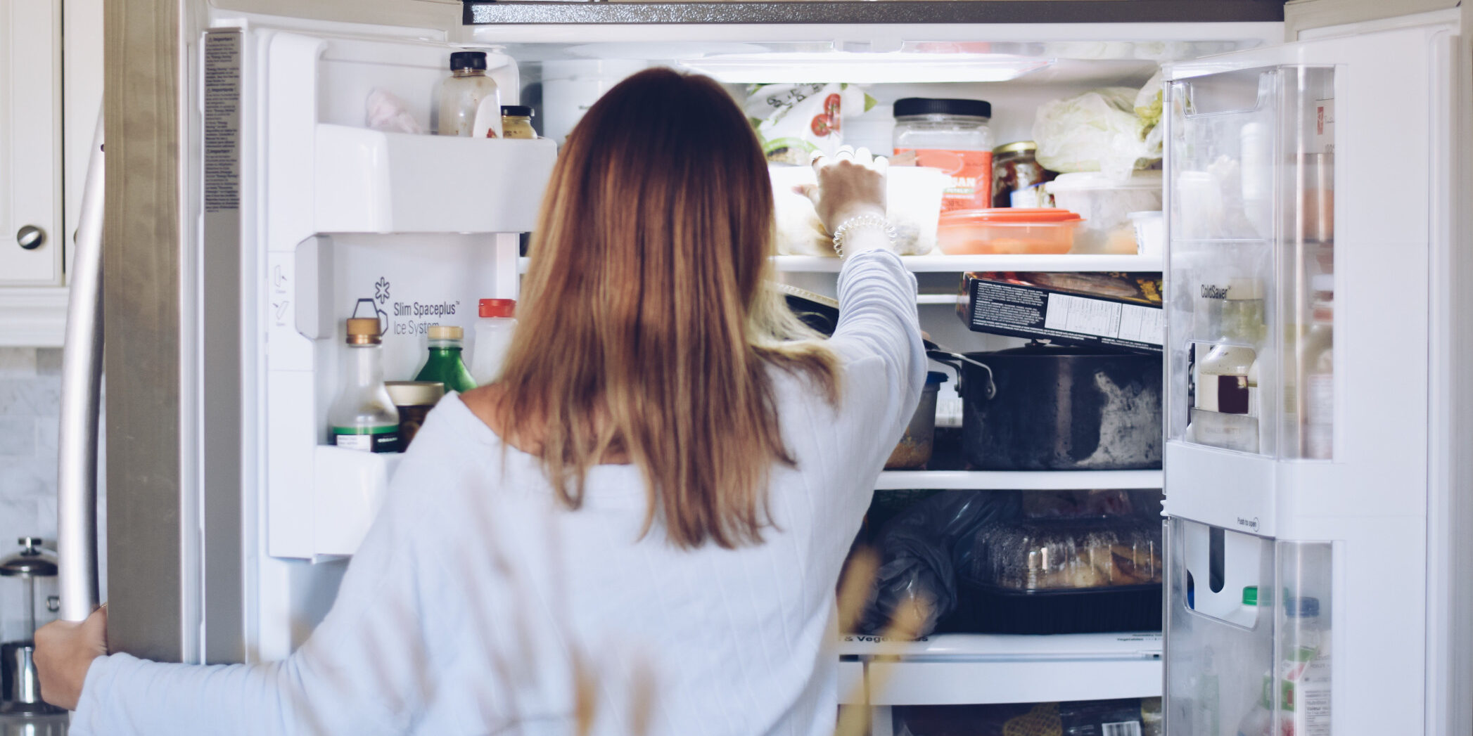 young-teenage-girl-is-taking-food-from-refrigerator_t20_gRrbBN